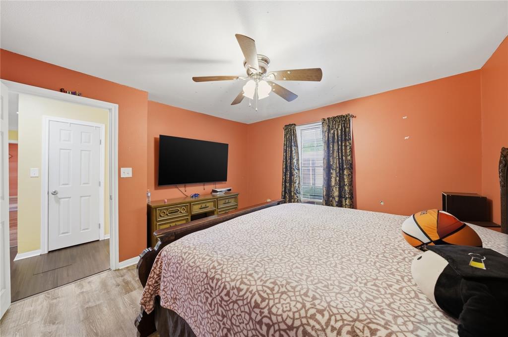 3624 Redbird Street Bellmead, TX 76705 - Photo 14 of 20 a bedroom with a bed and a flat screen tv