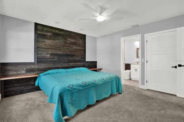 a living room with a bed and a chandelier