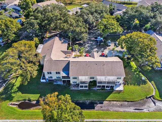 a view of a house with a yard and potted plants