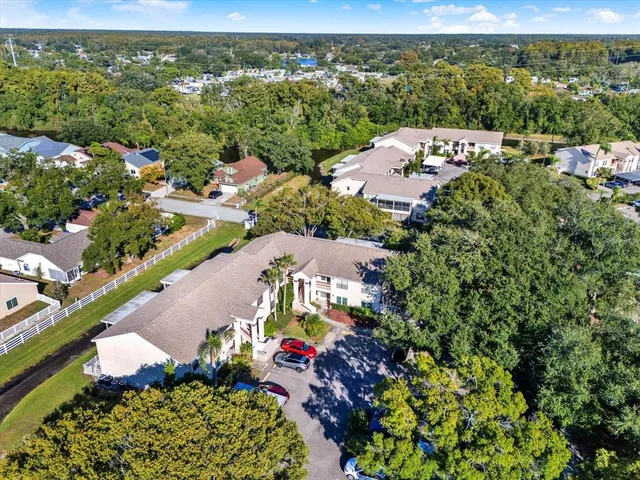 an aerial view of a city with lots of residential buildings ocean and mountain view in back