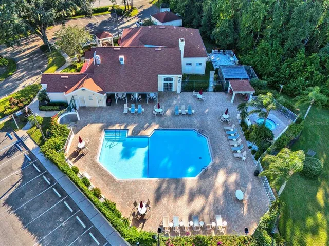 an aerial view of a house with yard swimming pool and outdoor seating
