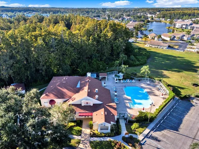 an aerial view of residential houses with outdoor space