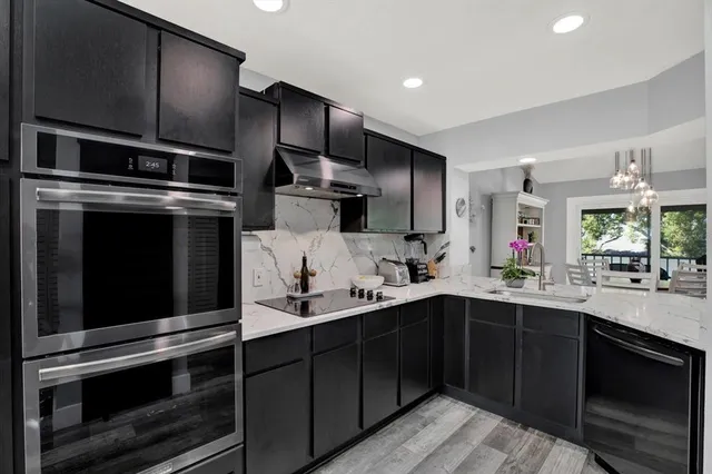 a kitchen with a sink stainless steel appliances and cabinets