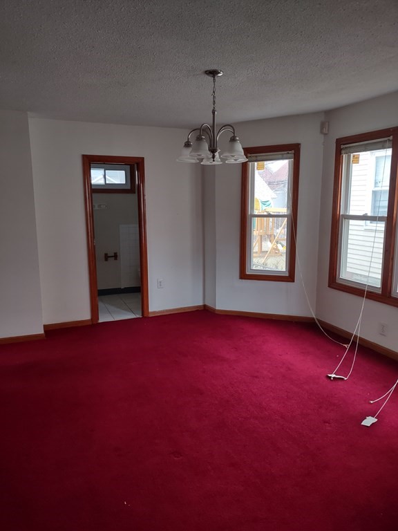 112 Marlborough Street Springfield, MA 01109 - Photo 3 of 22 a view of empty room with windows and ceiling fan