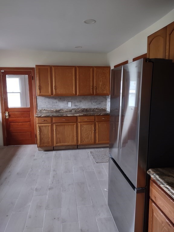 112 Marlborough Street Springfield, MA 01109 - Photo 5 of 22 a kitchen with granite countertop a refrigerator and a sink