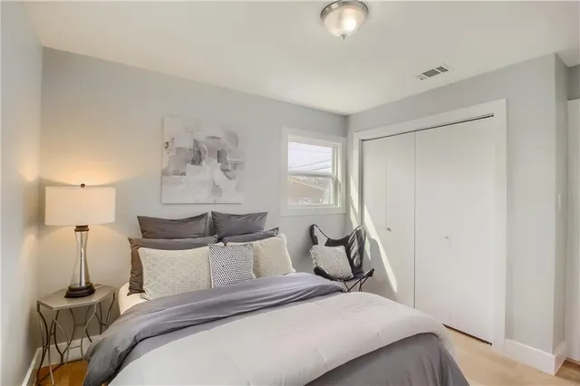 a bedroom with a bed and a lamp