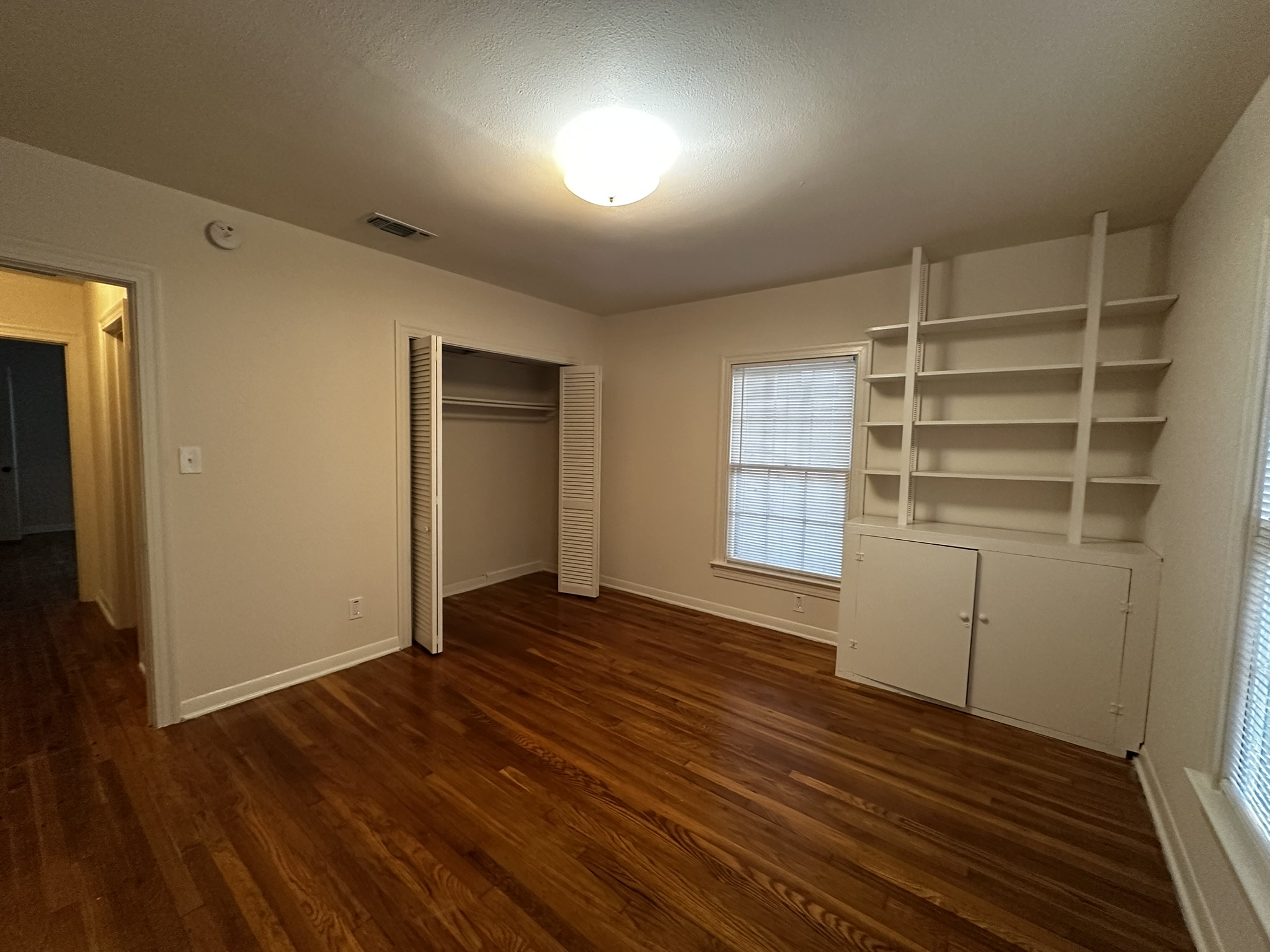 3903 Ridgelea Drive Austin, TX 78731 - Photo 14 of 17 Rich hardwood floors and classic built-in shelving define this versatile room.