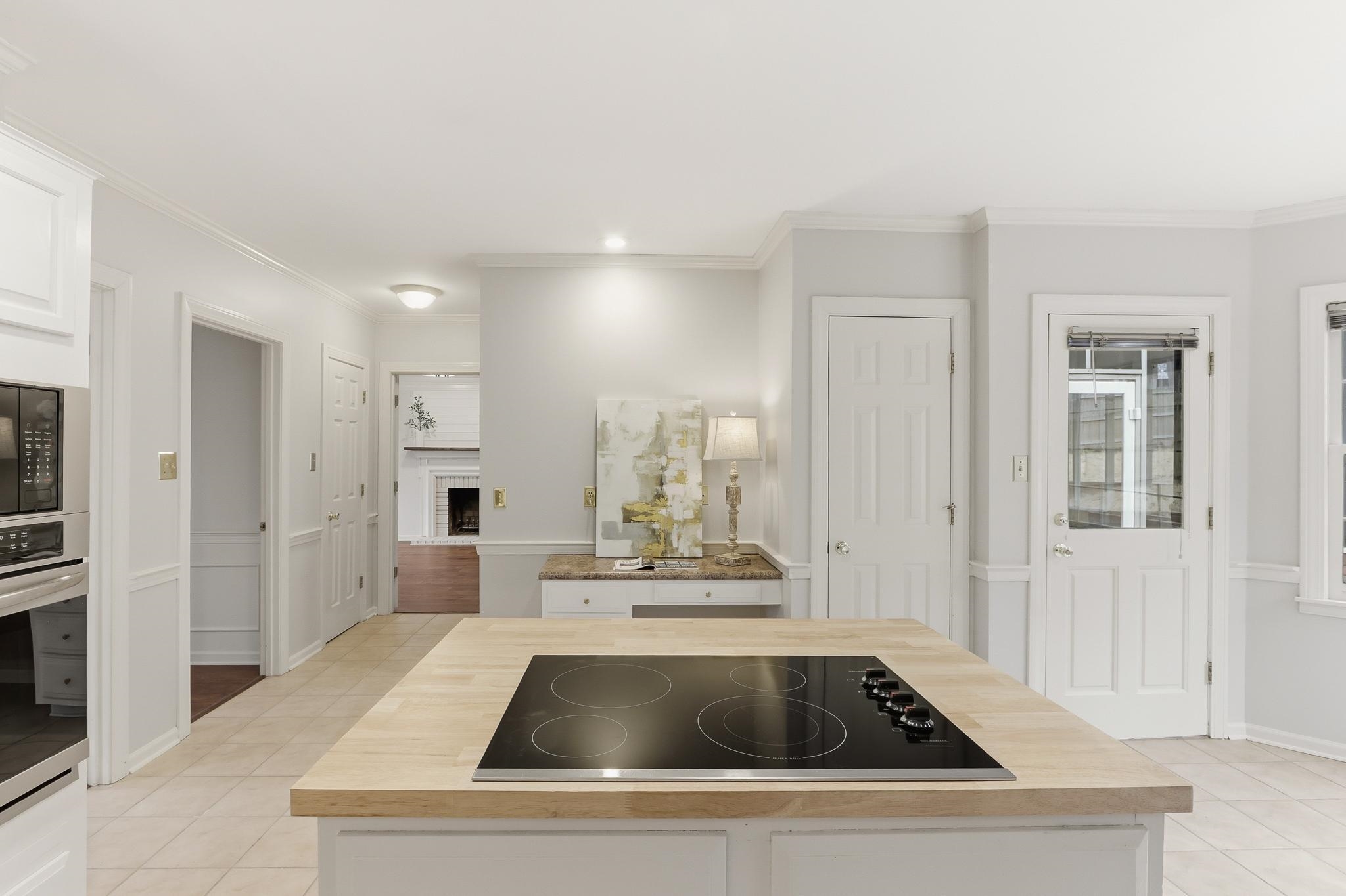 8372 Bazemore Road Cordova, TN 38018 - Photo 14 of 40 a kitchen with kitchen island white cabinets and refrigerator