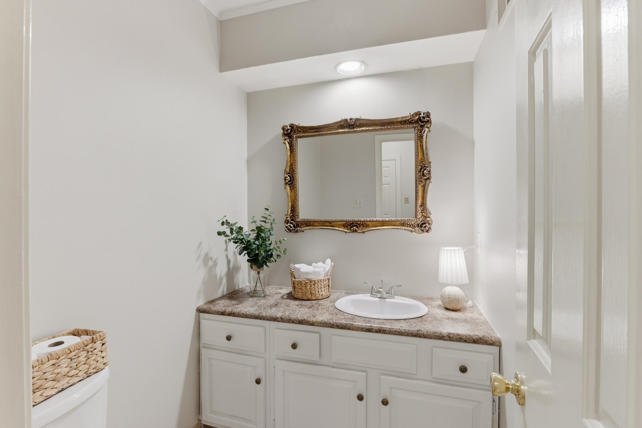 8372 Bazemore Road Cordova, TN 38018 - Photo 15 of 40 a bathroom with a granite countertop sink and a mirror