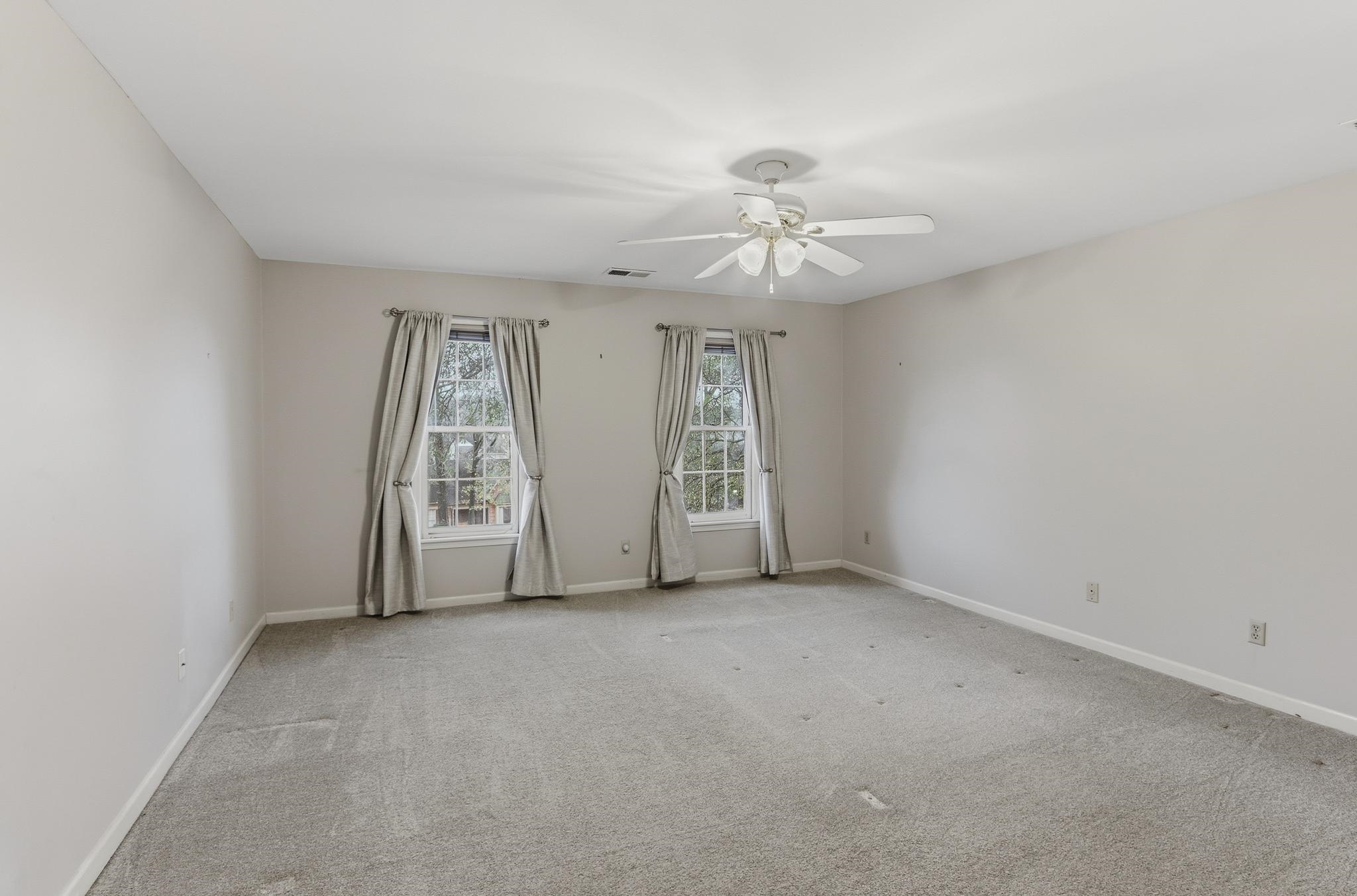 8372 Bazemore Road Cordova, TN 38018 - Photo 19 of 40 an empty room with windows and fan
