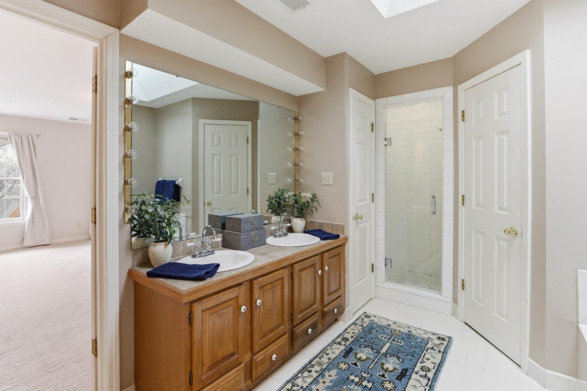 8372 Bazemore Road Cordova, TN 38018 - Photo 20 of 40 a bathroom with a sink a mirror and a shower