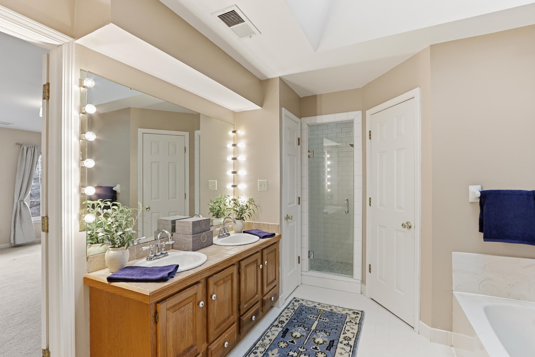 8372 Bazemore Road Cordova, TN 38018 - Photo 22 of 40 a bathroom with sink a mirror and a shower