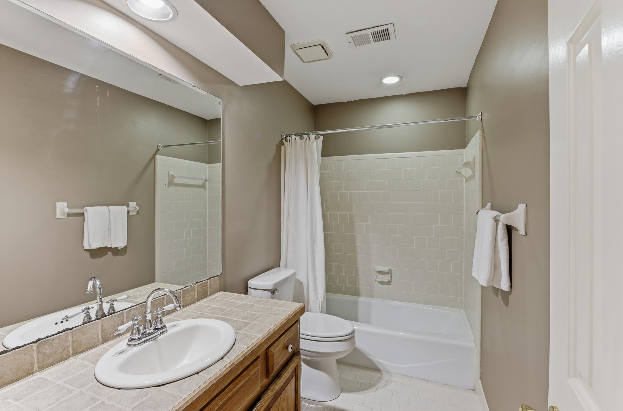8372 Bazemore Road Cordova, TN 38018 - Photo 26 of 40 a bathroom with a sink toilet and shower