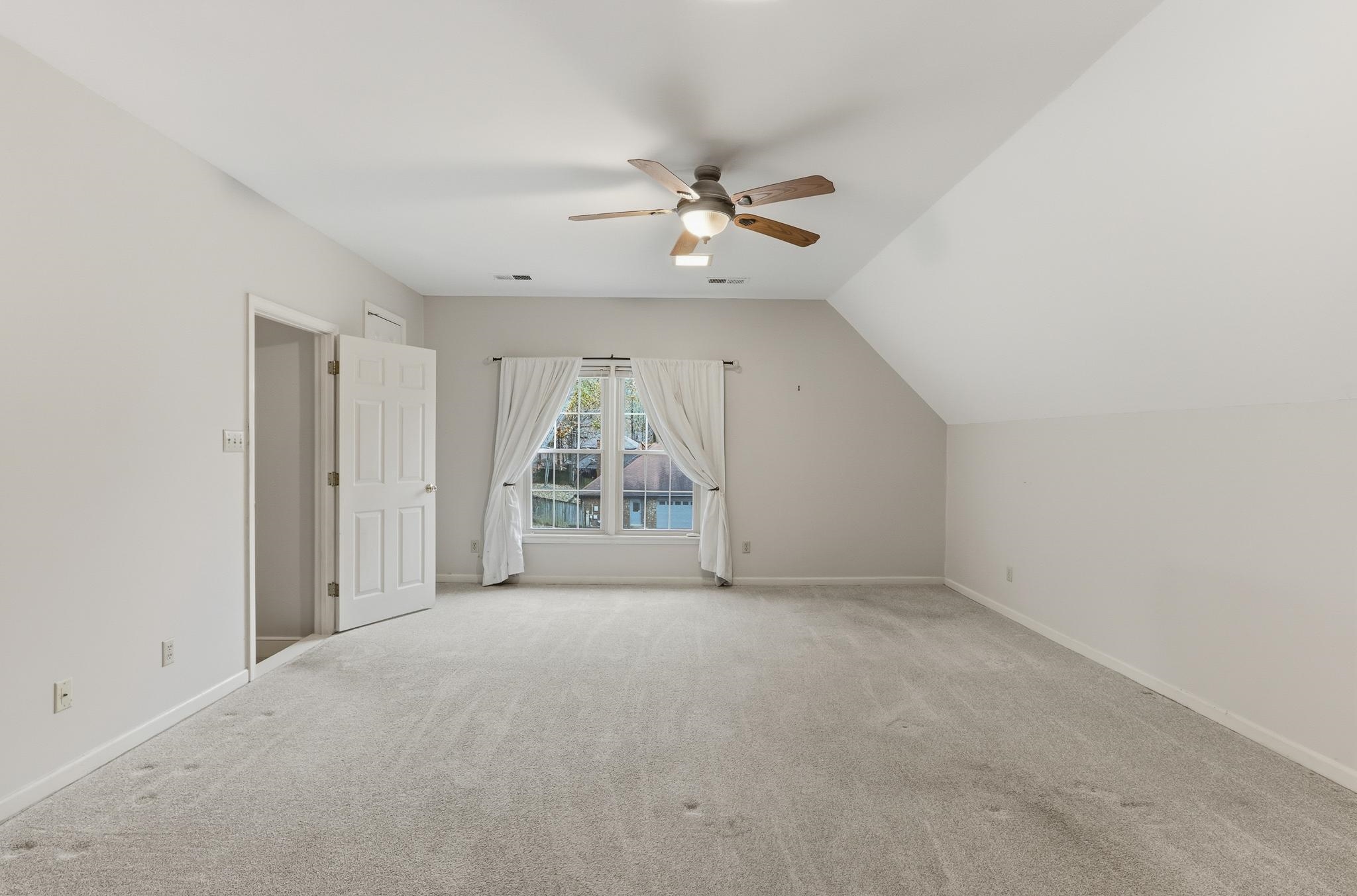 8372 Bazemore Road Cordova, TN 38018 - Photo 27 of 40 an empty room with a ceiling fan and window