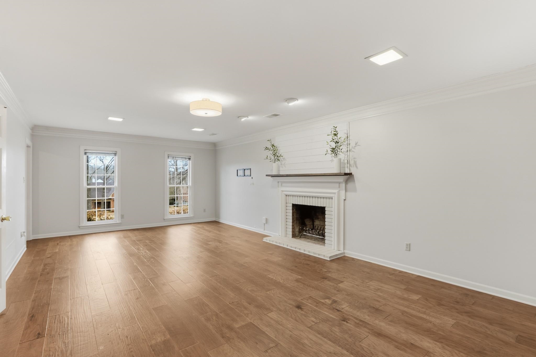 8372 Bazemore Road Cordova, TN 38018 - Photo 3 of 40 a view of an empty room with wooden floor and a window