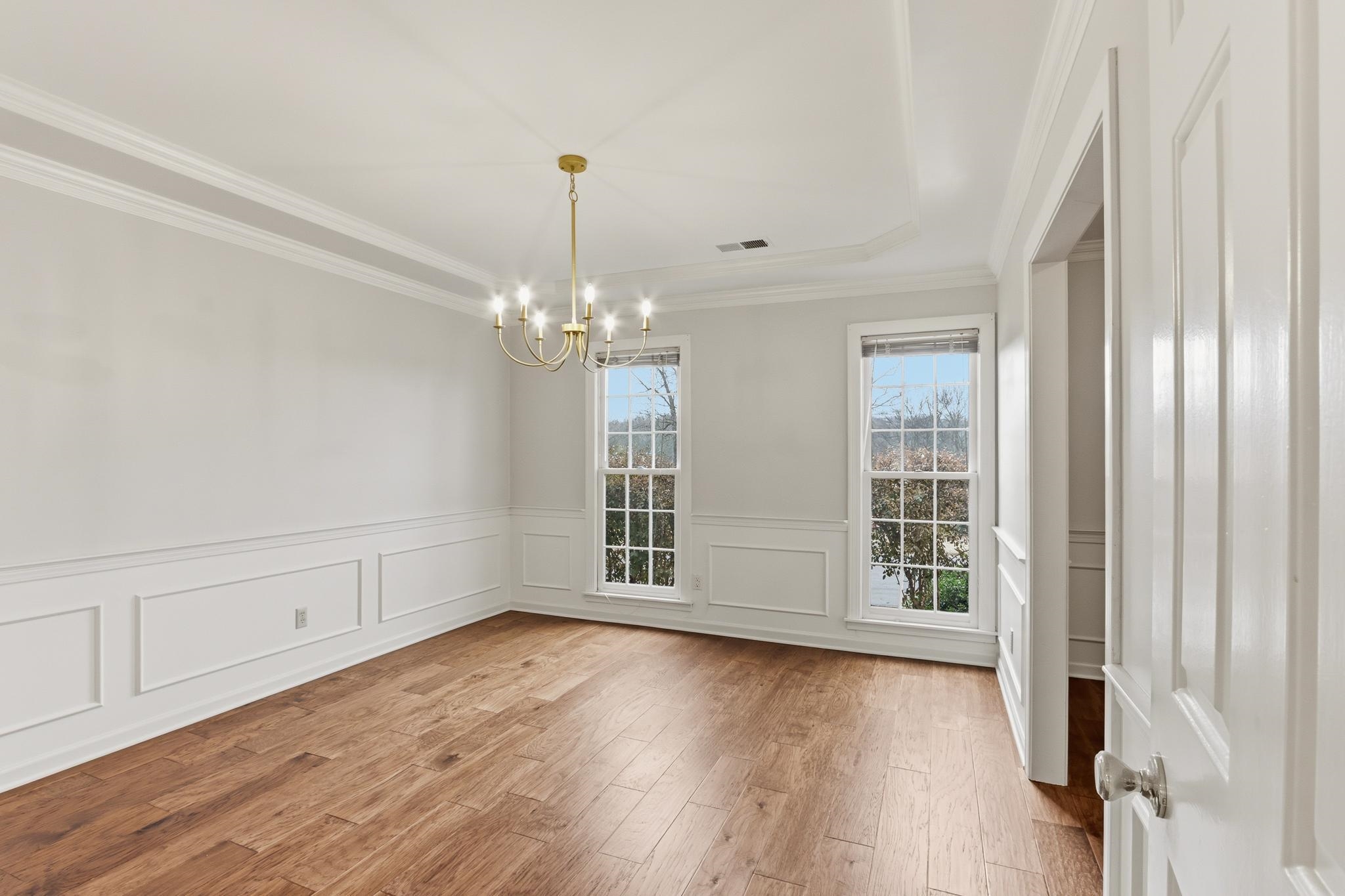 8372 Bazemore Road Cordova, TN 38018 - Photo 5 of 40 a view of an empty room with wooden floor and a window