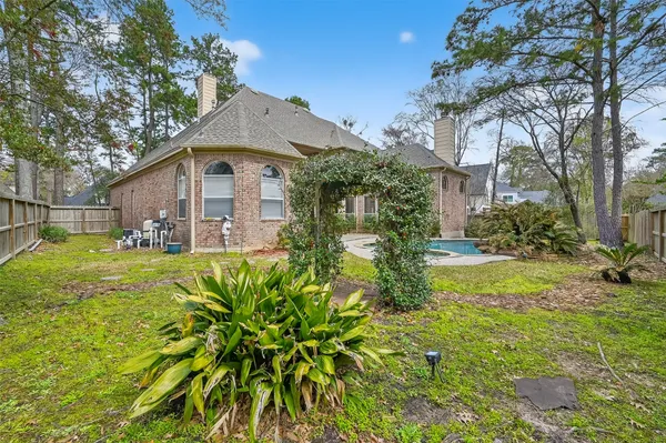 a view of a house with a yard and potted plants