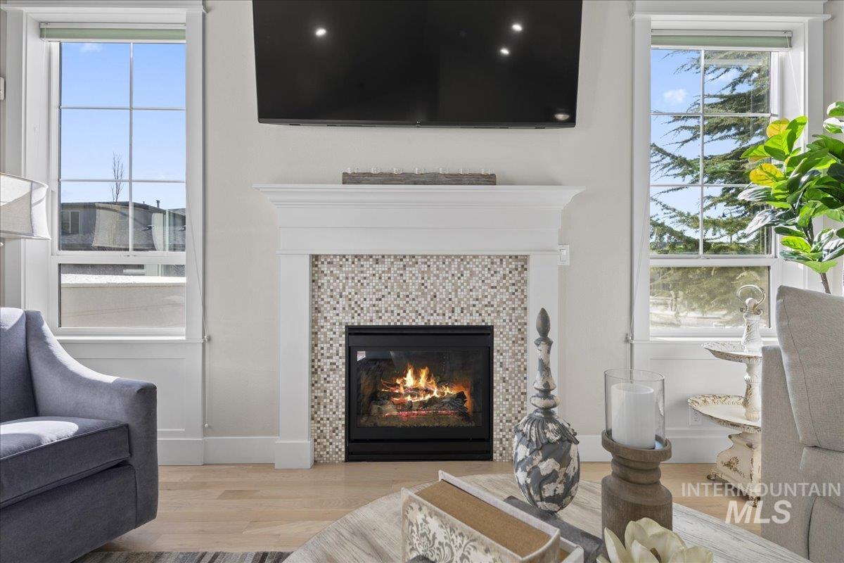 2856 South Wise Way Boise, ID 83716 - Photo 12 of 47 Living area with wood finished floors and a tile fireplace