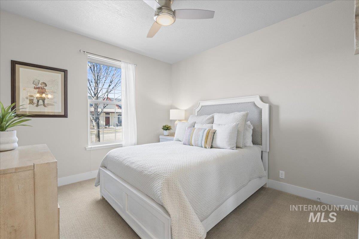 2856 South Wise Way Boise, ID 83716 - Photo 24 of 47 Bedroom featuring carpet flooring, ceiling fan, and a textured ceiling