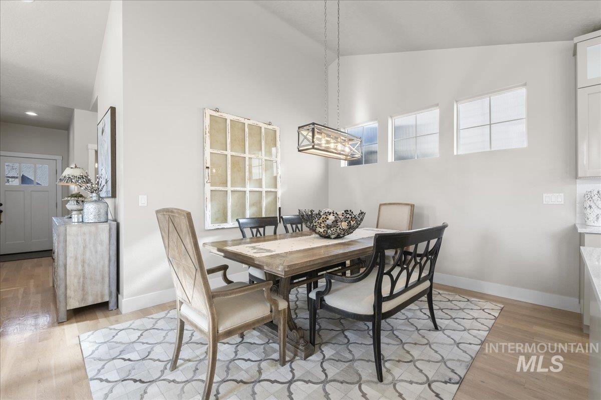2856 South Wise Way Boise, ID 83716 - Photo 26 of 47 Dining space featuring light wood finished floors and a high ceiling