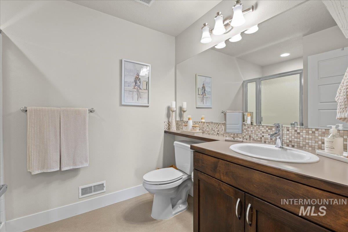 2856 South Wise Way Boise, ID 83716 - Photo 31 of 47 Bathroom featuring vanity, a shower stall, and tasteful backsplash