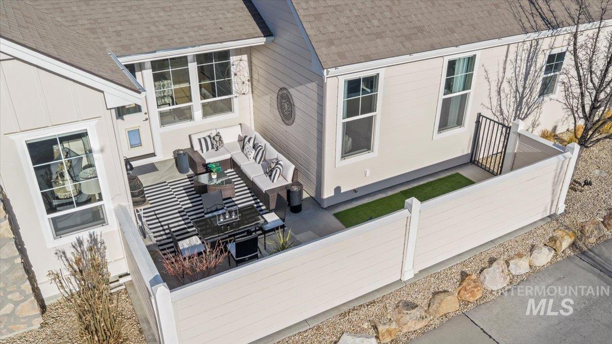 2856 South Wise Way Boise, ID 83716 - Photo 37 of 47 View of home's exterior with a shingled roof, a fenced front yard, and a patio