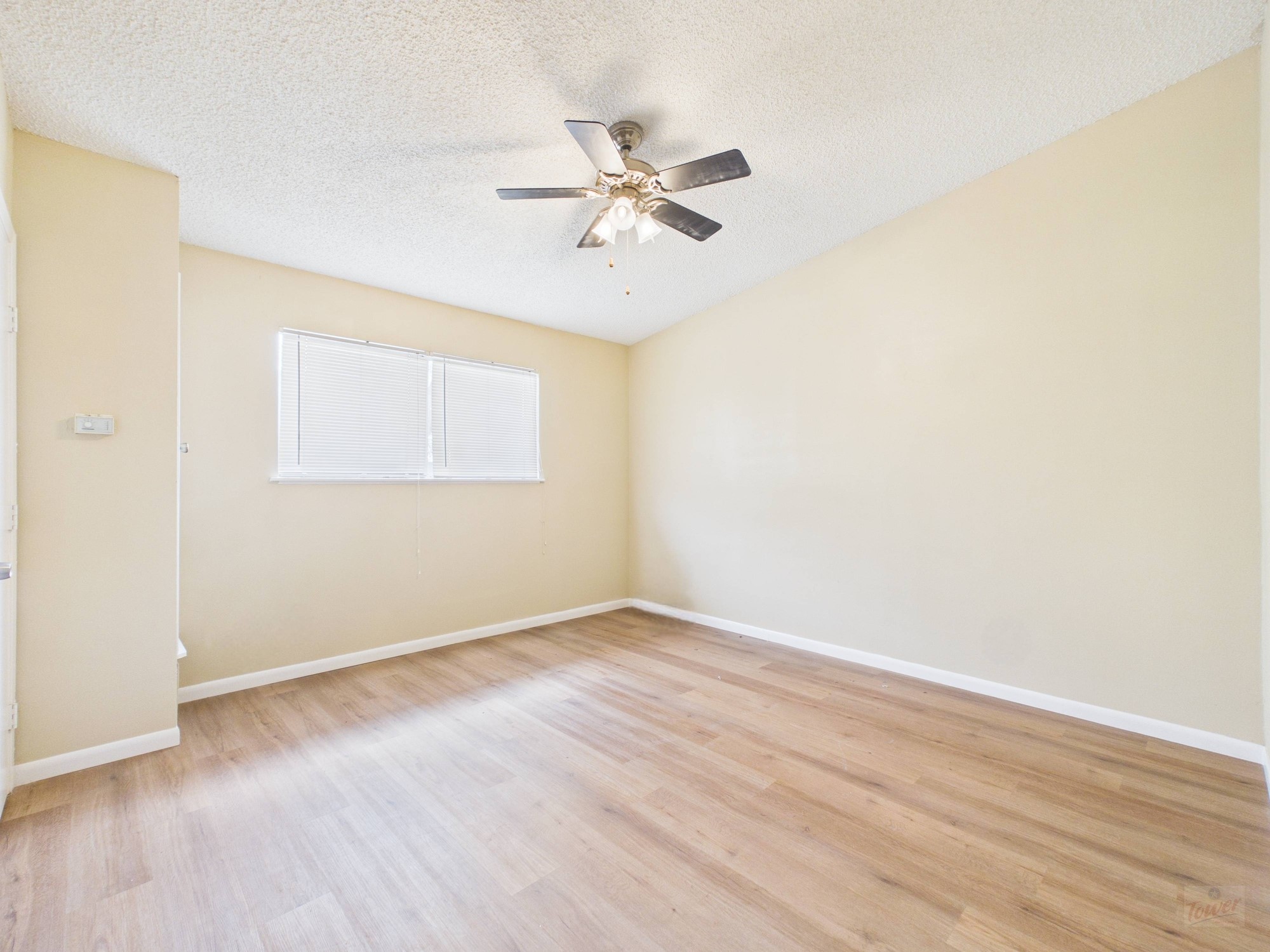 616 West 51st Street, Unit 101 Austin, TX 78751 - Photo 14 of 16 a view of a room with wooden floor and a ceiling fan