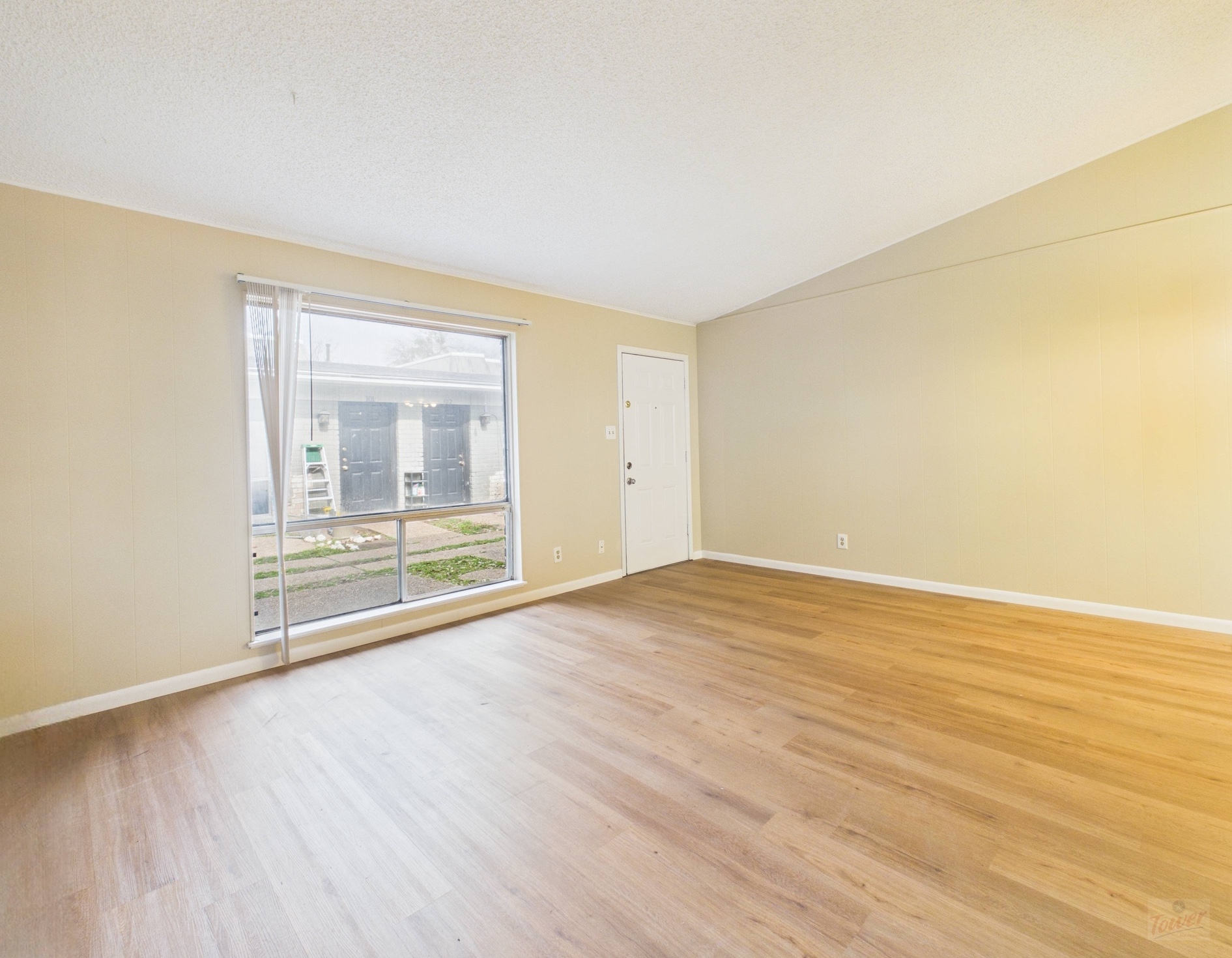 616 West 51st Street, Unit 101 Austin, TX 78751 - Photo 3 of 16 a view of an empty room with wooden floor and a window