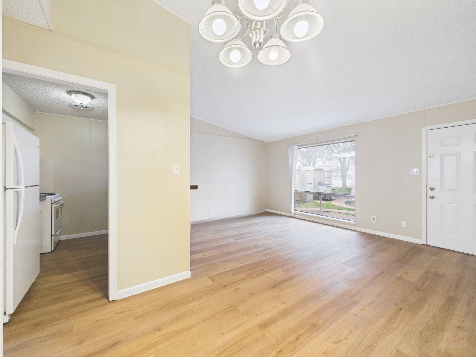 616 West 51st Street, Unit 101 Austin, TX 78751 - Photo 4 of 16 an empty room with wooden floor and windows