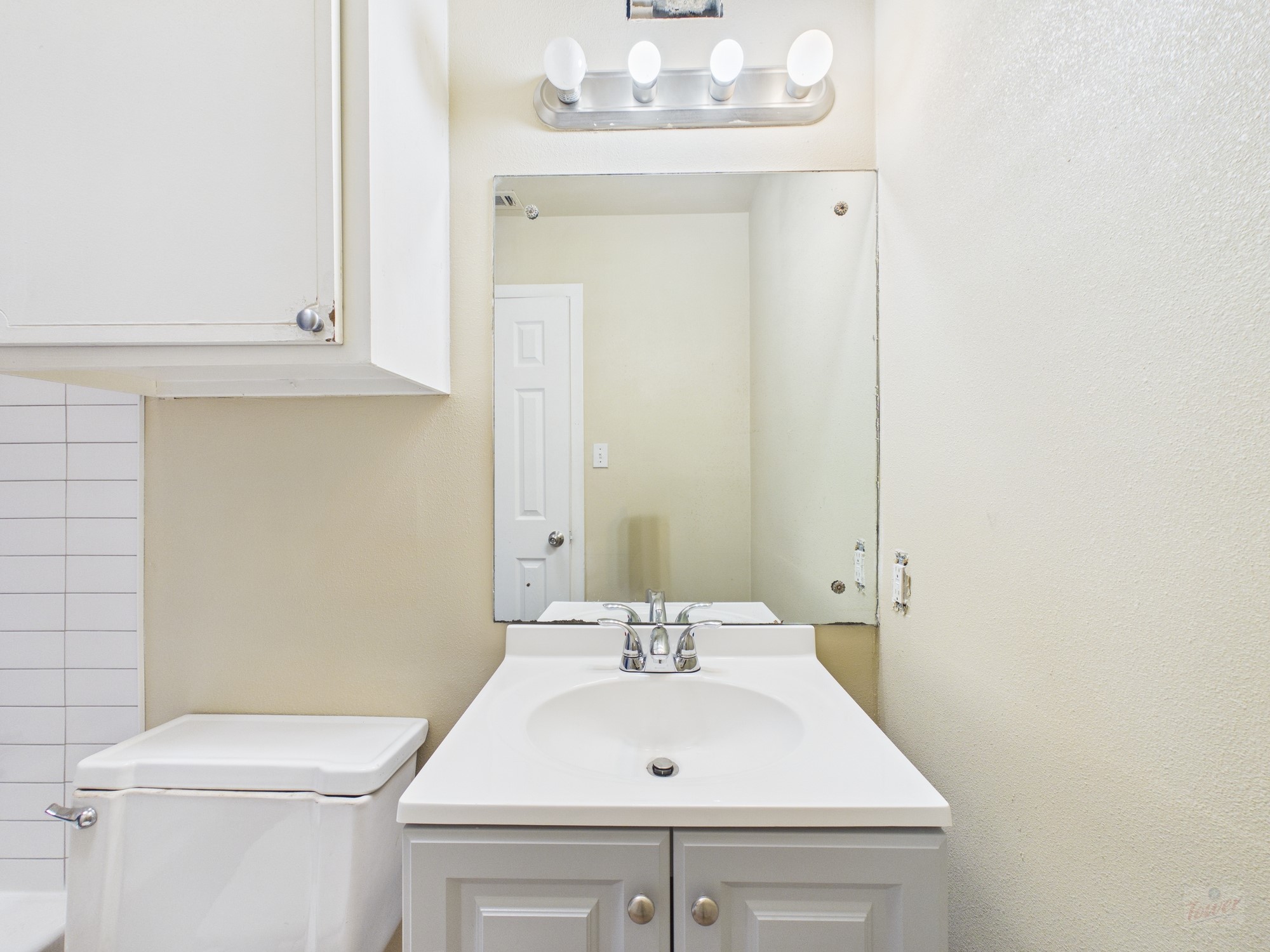 616 West 51st Street, Unit 101 Austin, TX 78751 - Photo 9 of 16 a bathroom with a sink a toilet and a mirror