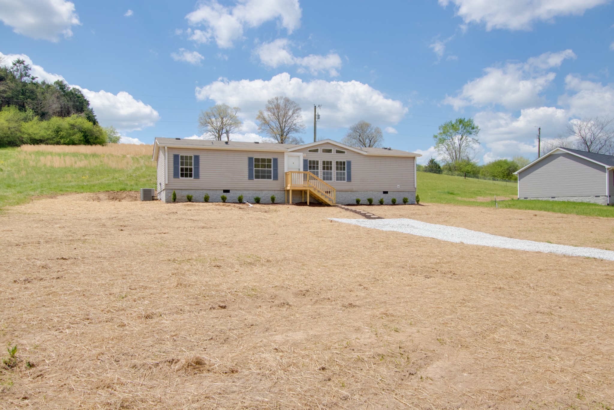 24 Young Road Buffalo Valley, TN 38548 - Photo 3 of 33 a front view of a house with a yard and garage
