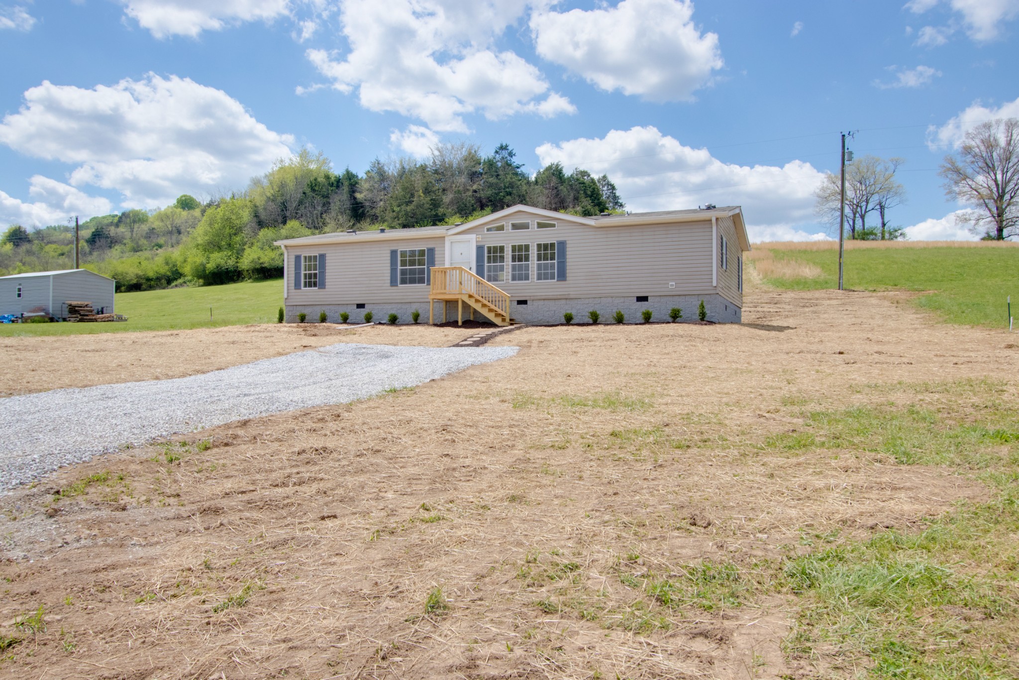 24 Young Road Buffalo Valley, TN 38548 - Photo 4 of 33 a front view of a house with a yard and garage