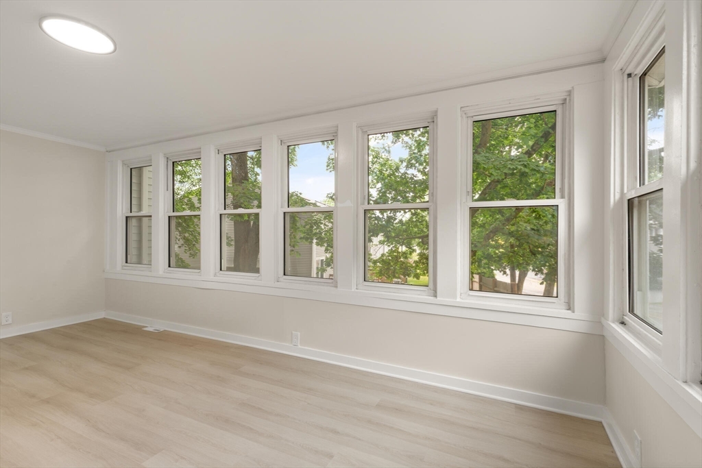25 Norfolk Street Canton, MA 02021 - Photo 11 of 31 an empty room with wooden floor and windows