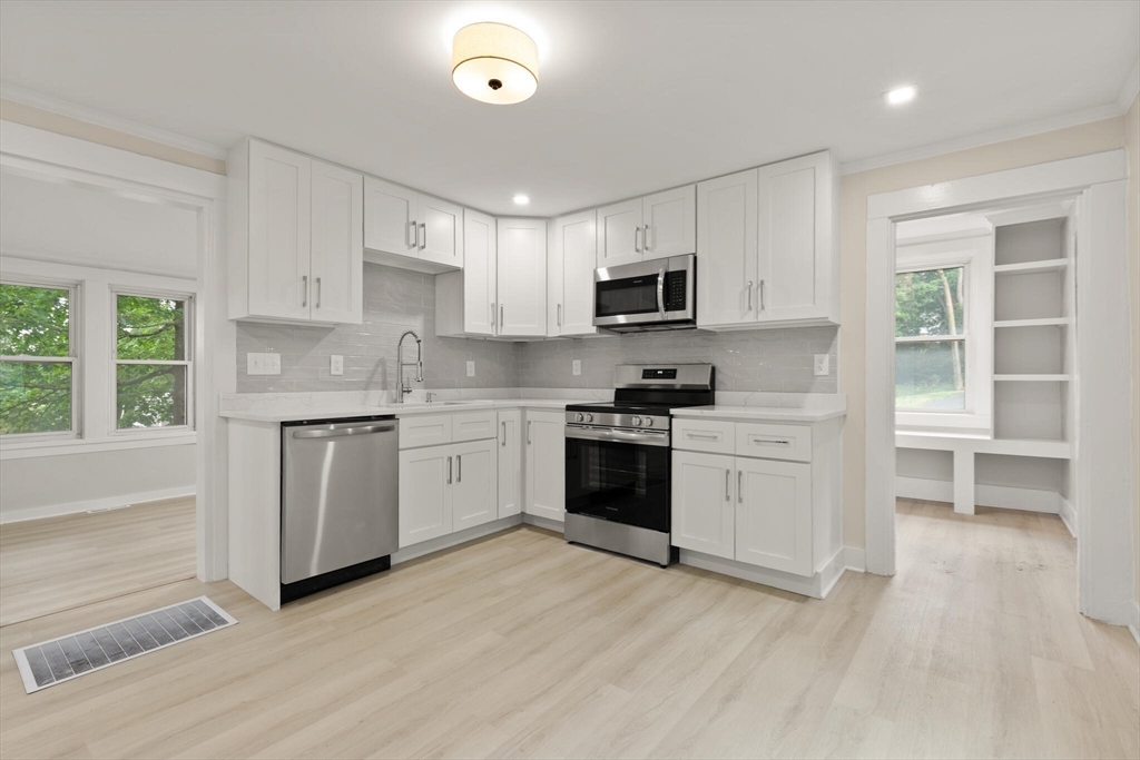 25 Norfolk Street Canton, MA 02021 - Photo 15 of 31 a kitchen with granite countertop white cabinets and white stainless steel appliances