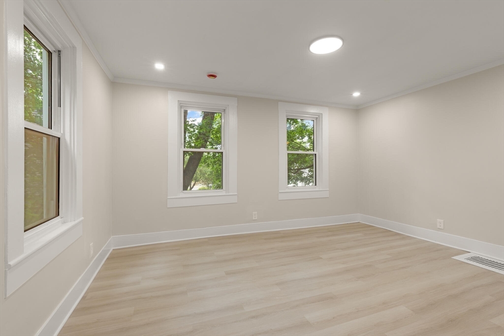 25 Norfolk Street Canton, MA 02021 - Photo 16 of 31 an empty room with wooden floor and windows
