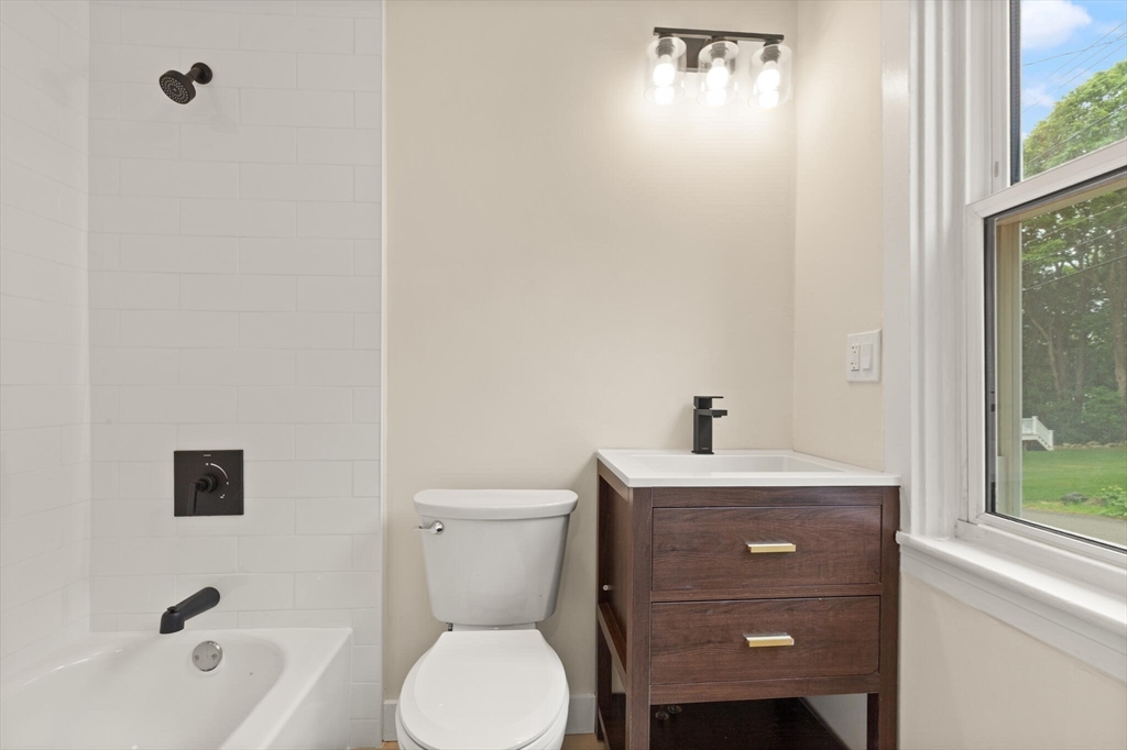 25 Norfolk Street Canton, MA 02021 - Photo 24 of 31 a bathroom with a sink a toilet and shower
