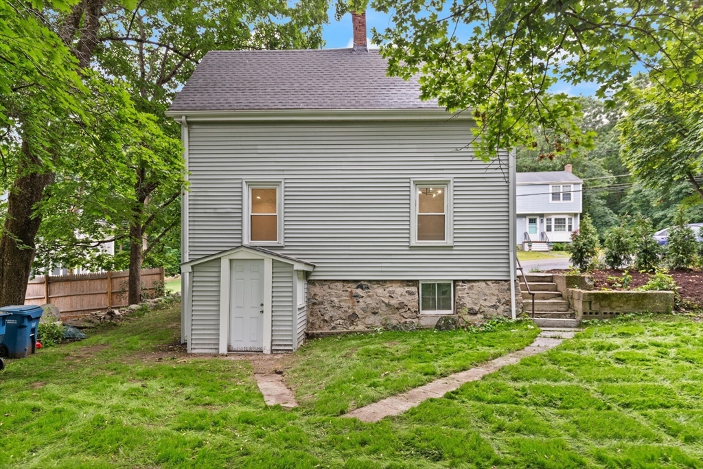 25 Norfolk Street Canton, MA 02021 - Photo 25 of 31 a brick house with a small yard and plants