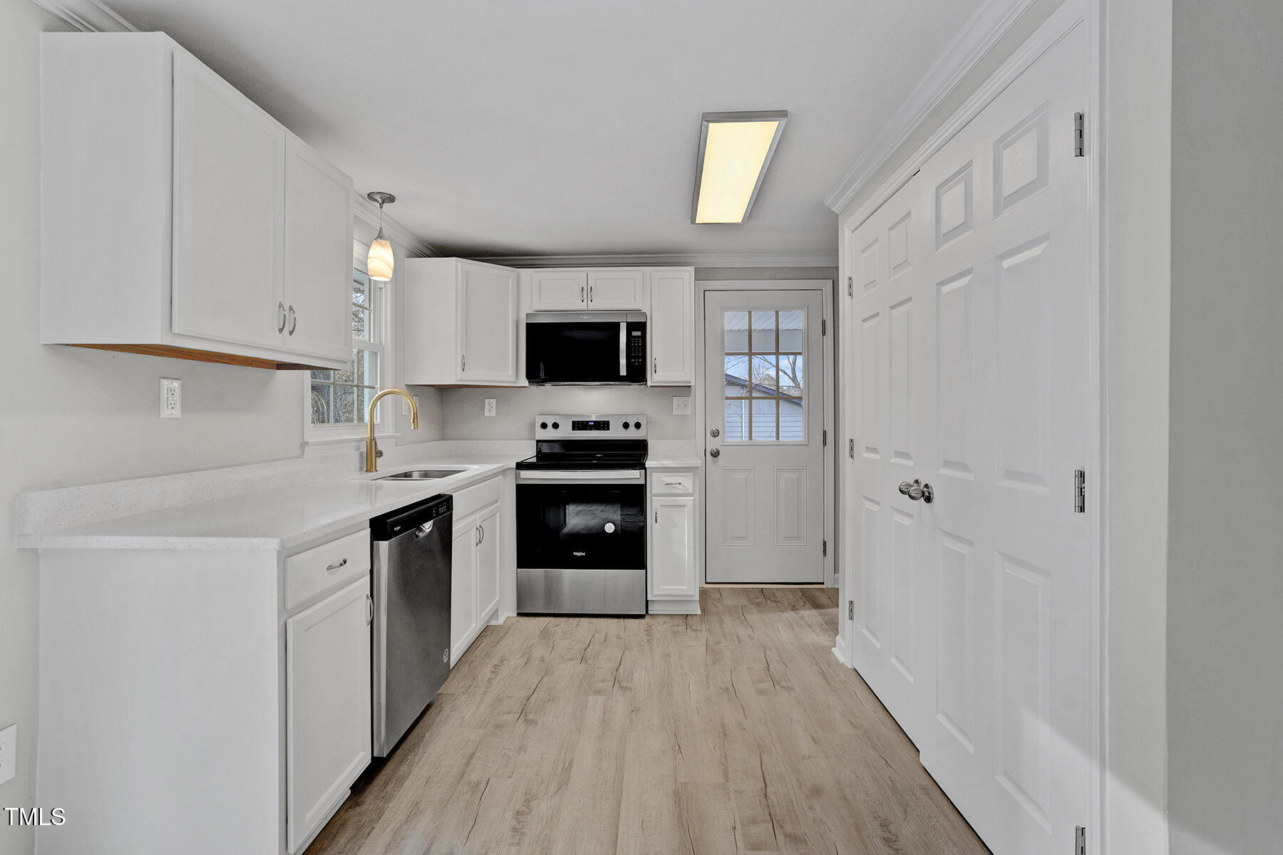 7516 Fox Road Raleigh, NC 27616 - Photo 11 of 31 a kitchen with cabinets a counter top space stainless steel appliances and a window