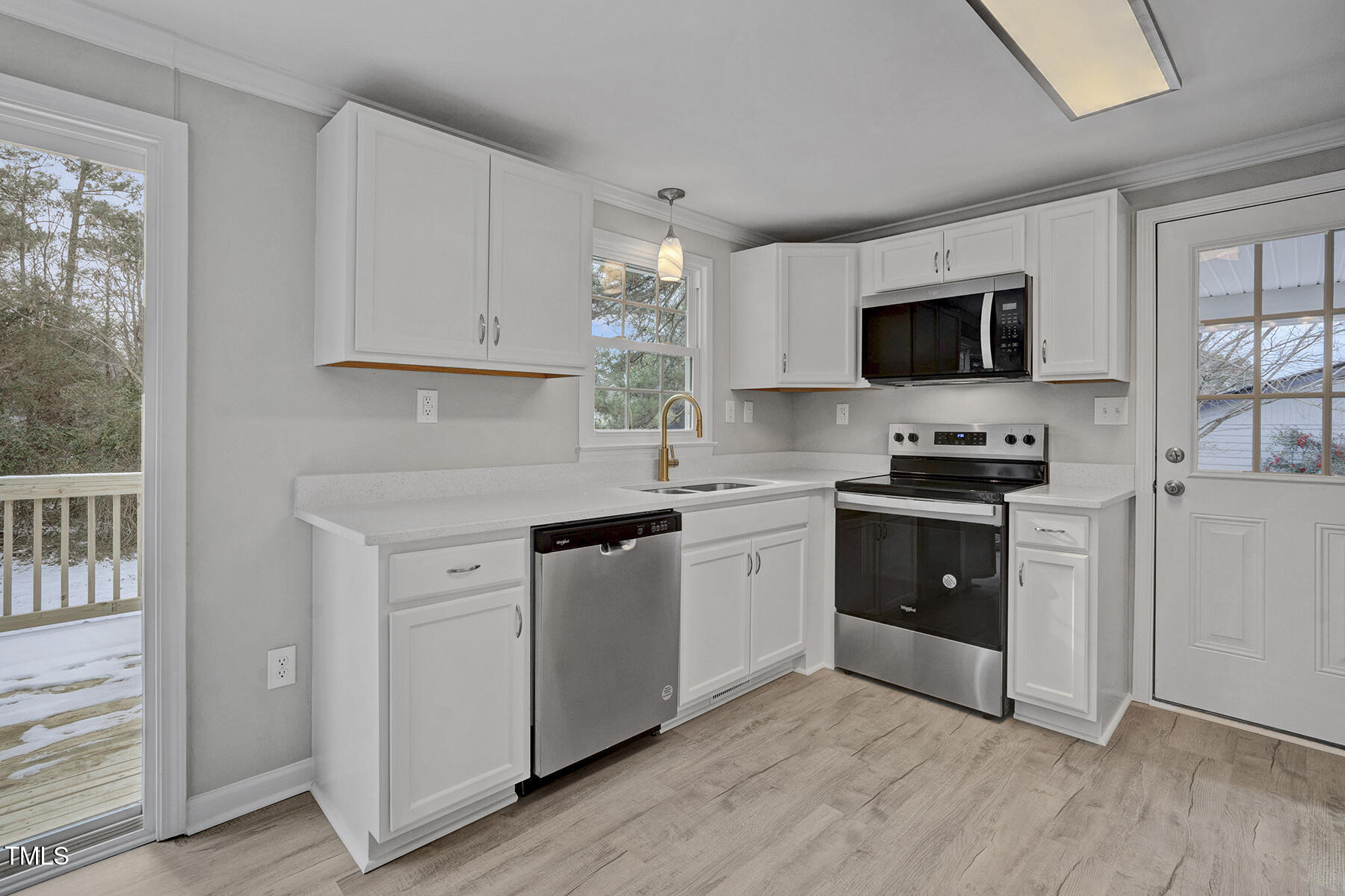 7516 Fox Road Raleigh, NC 27616 - Photo 12 of 31 a kitchen with kitchen island granite countertop a sink cabinets and stainless steel appliances