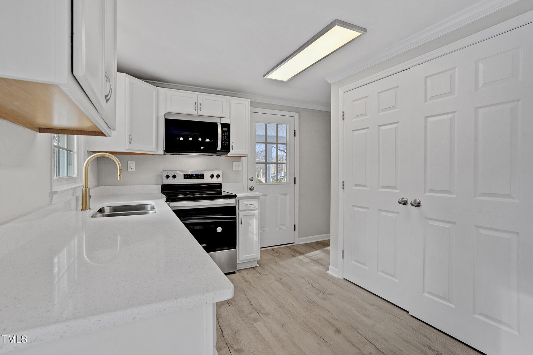7516 Fox Road Raleigh, NC 27616 - Photo 13 of 31 a kitchen with a refrigerator stove and a sink