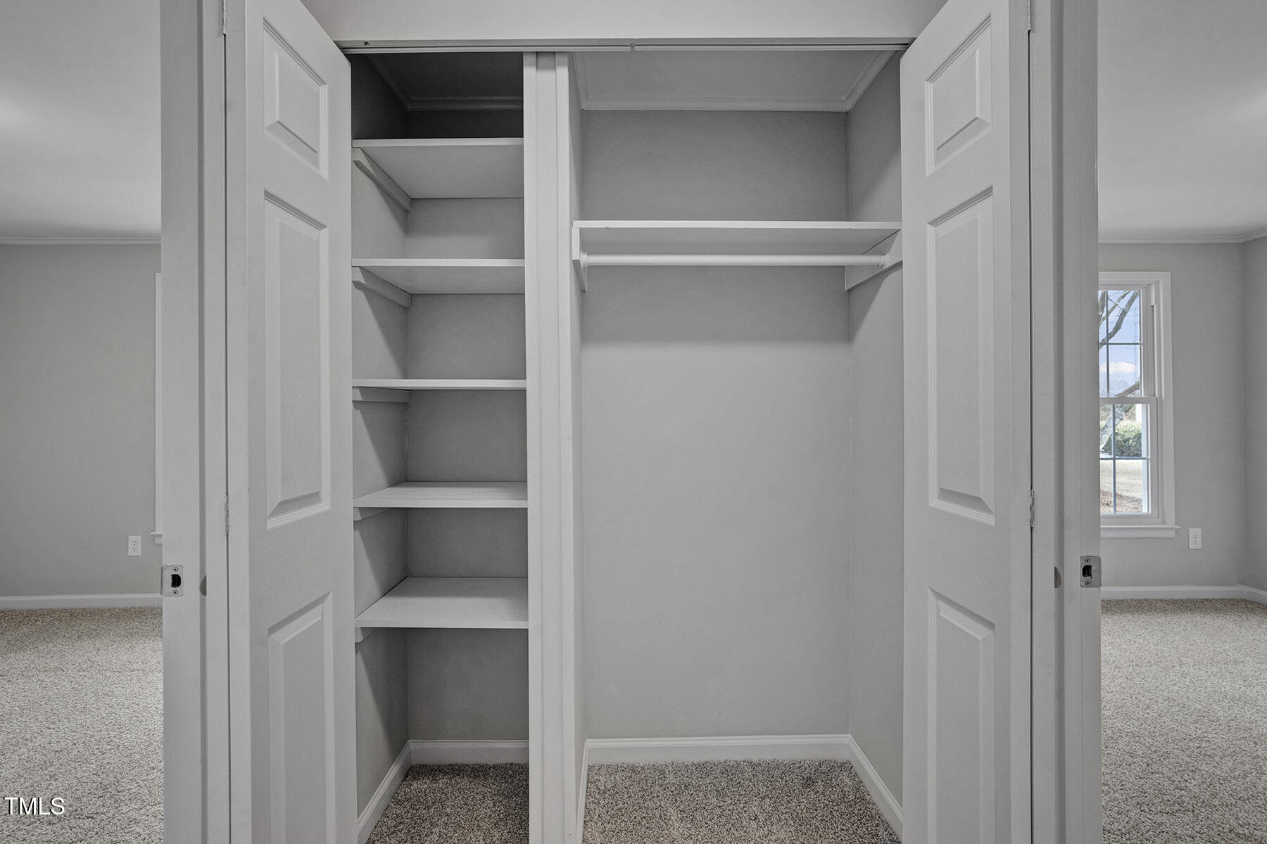 7516 Fox Road Raleigh, NC 27616 - Photo 16 of 31 a view of walk in closet with empty racks