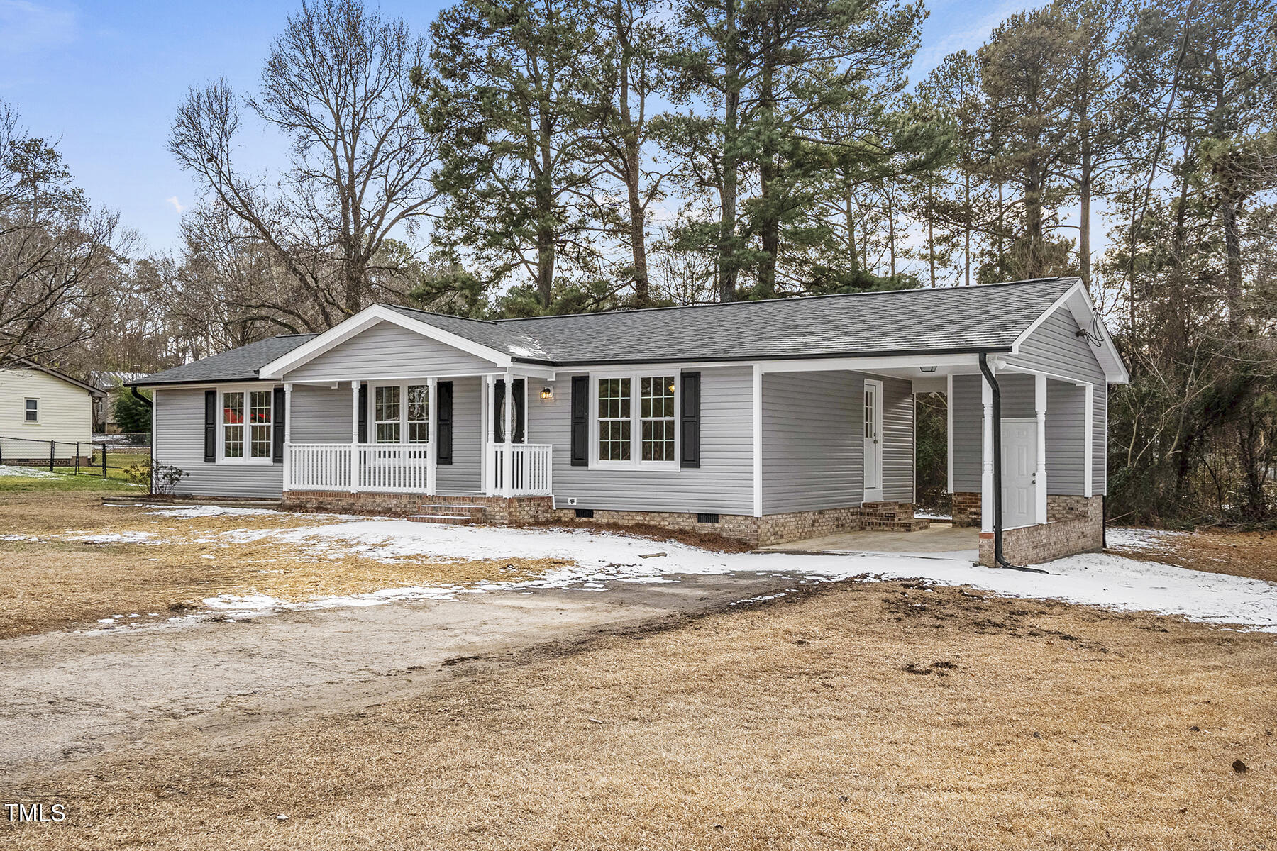 7516 Fox Road Raleigh, NC 27616 - Photo 3 of 31 a front view of a house with a dirt yard and large tree