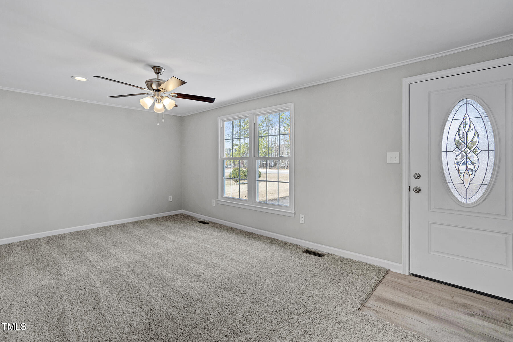 7516 Fox Road Raleigh, NC 27616 - Photo 6 of 31 a view of an empty room with window chandelier fan