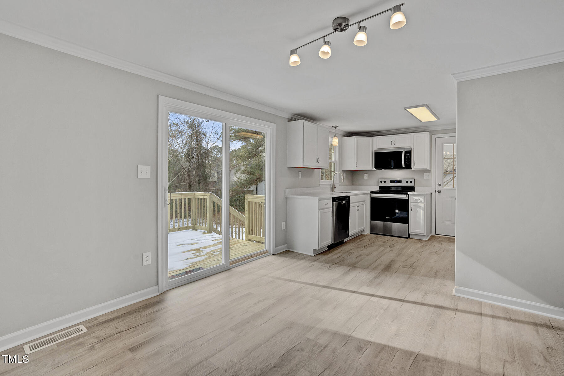 7516 Fox Road Raleigh, NC 27616 - Photo 9 of 31 a view of a kitchen with a microwave and a stove