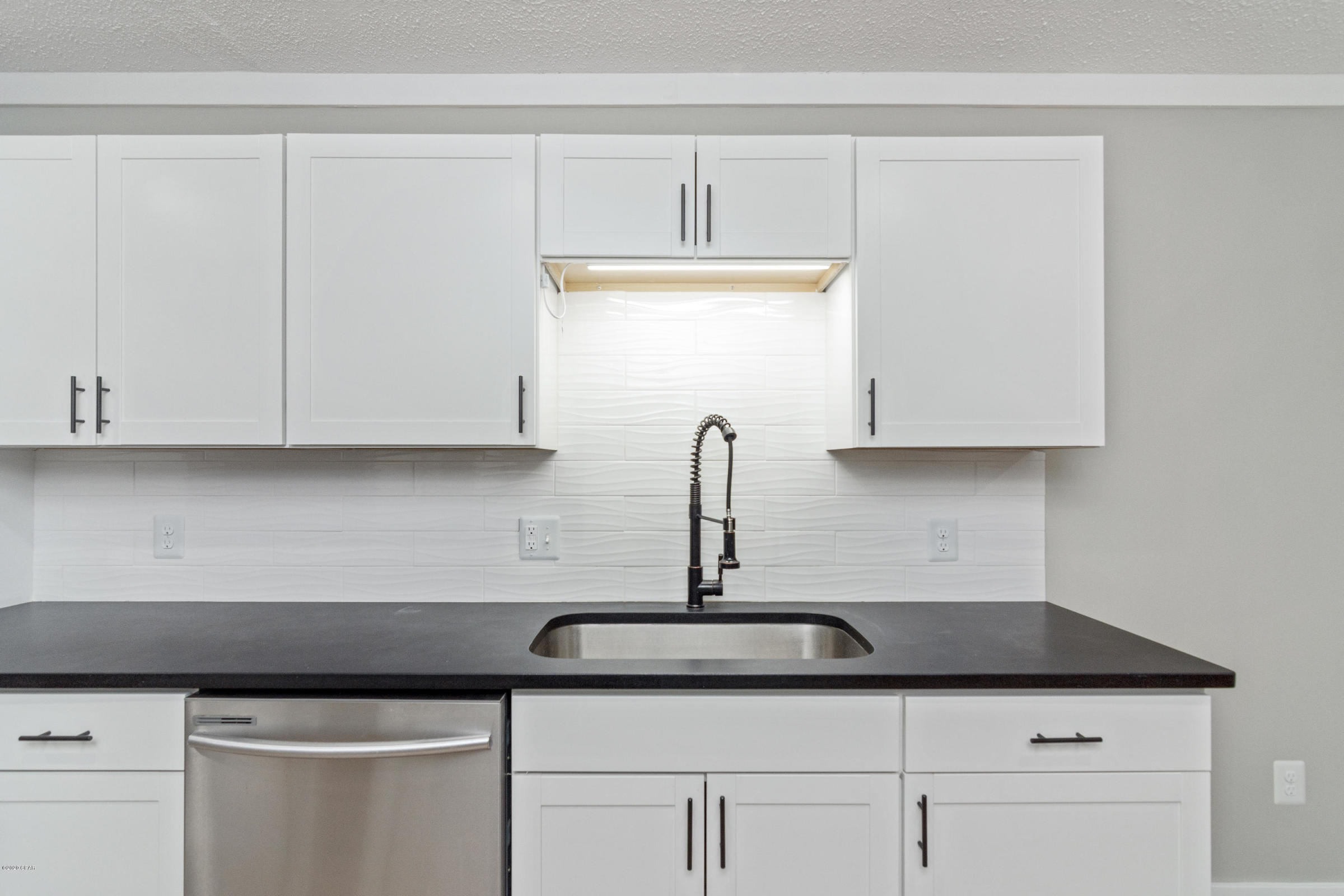 3057 Auburn Road Crestview, FL 32539 - Photo 15 of 30 a kitchen with a sink and cabinets