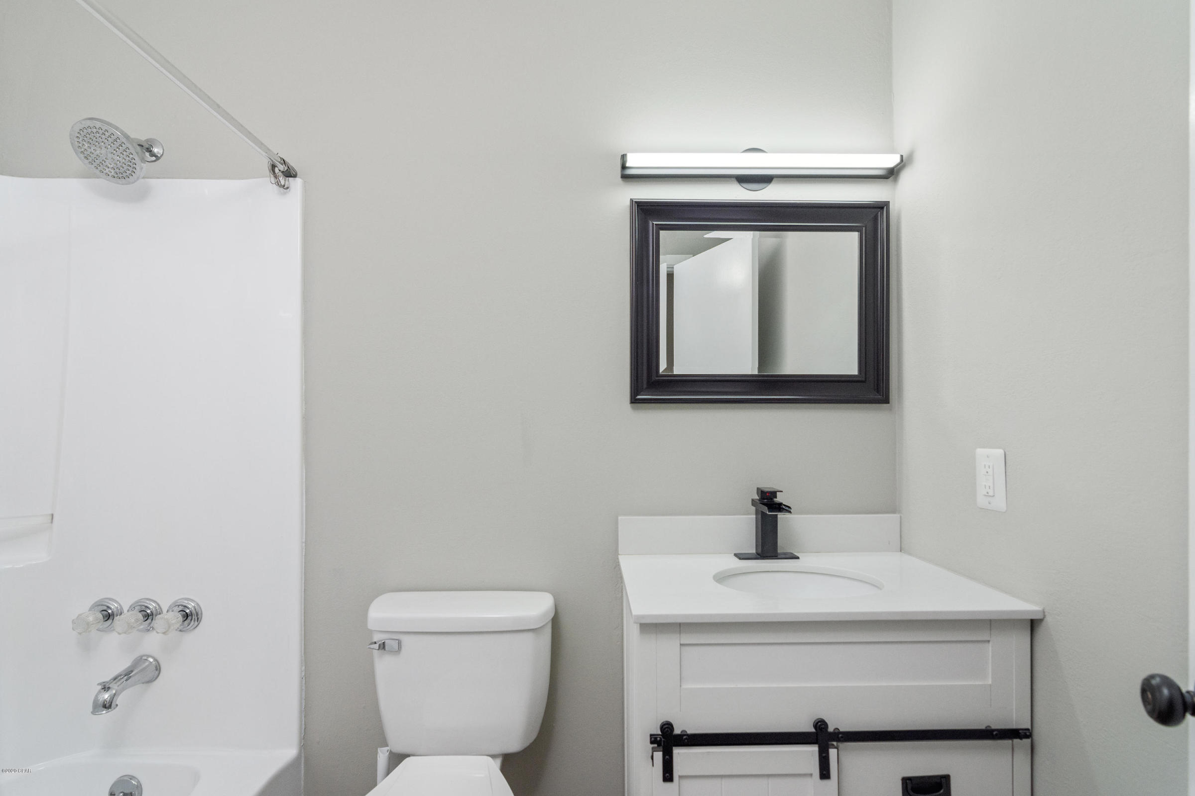 3057 Auburn Road Crestview, FL 32539 - Photo 18 of 30 a bathroom with a toilet a sink and mirror