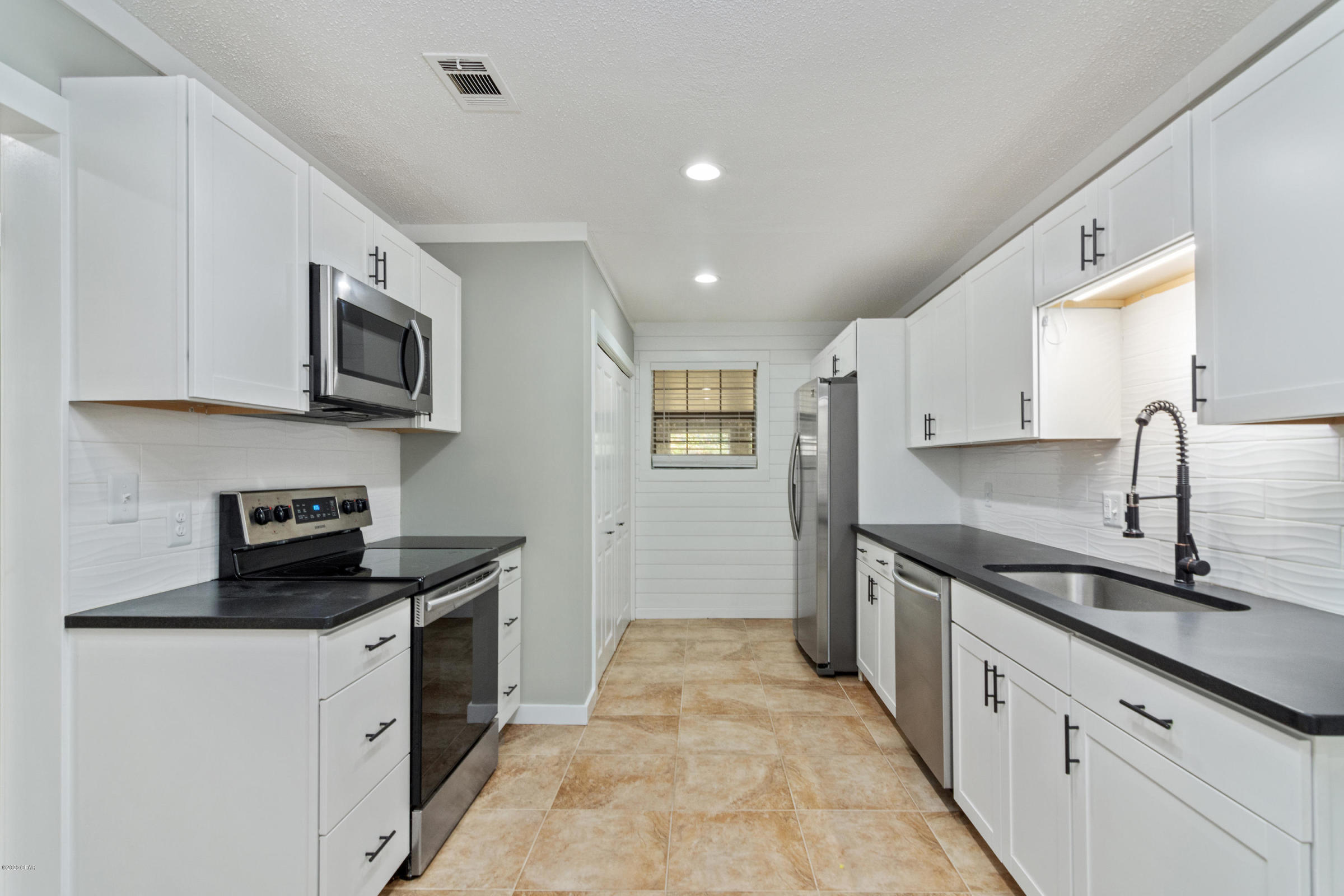 3057 Auburn Road Crestview, FL 32539 - Photo 10 of 30 a kitchen with stainless steel appliances granite countertop a sink and stove top oven