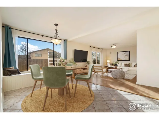 a view of an empty room with chandelier and a window