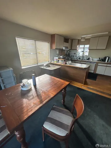 a room with dining table and chairs