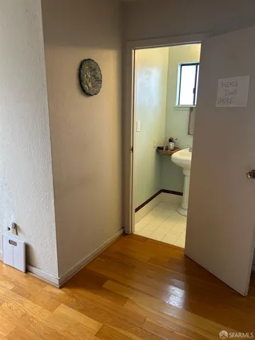 a view of a room with wooden floor and cabinet